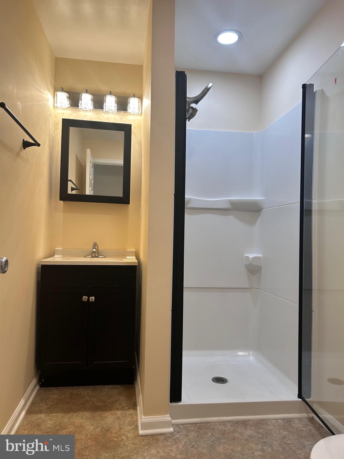 7617 Windsor Mill Road Windsor Mill, MD 21244 - Photo 45 of 49 a bathroom with a sink a mirror and shower