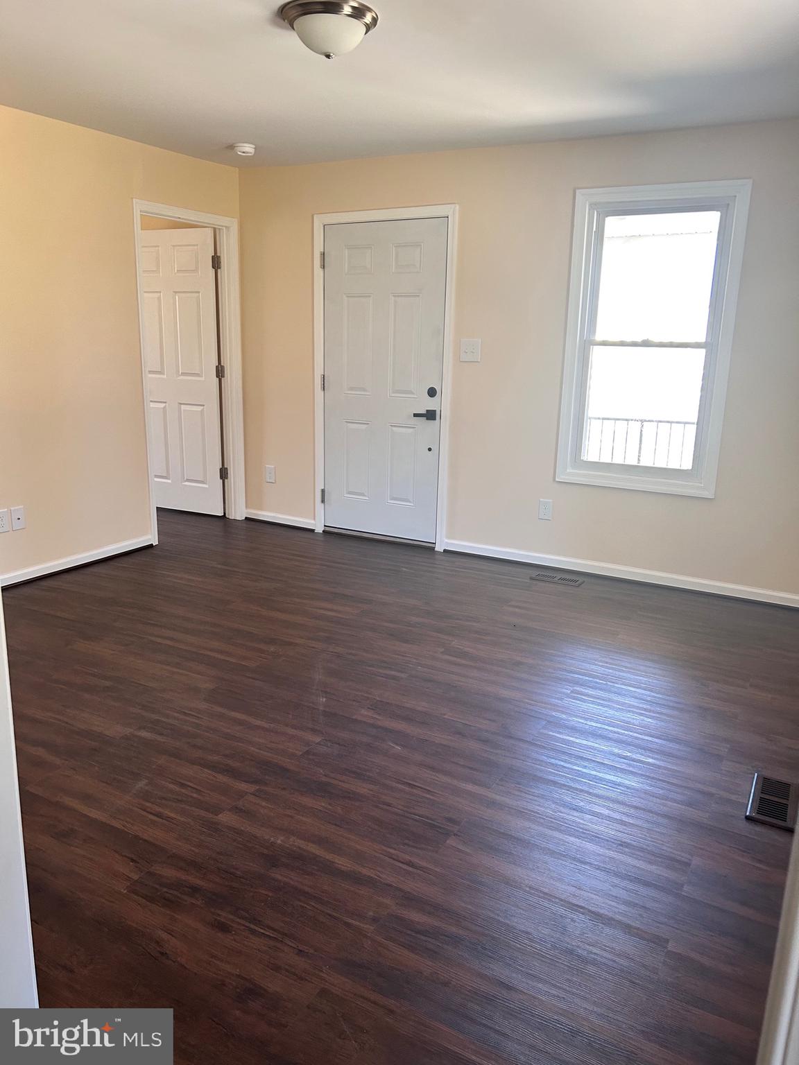 7617 Windsor Mill Road Windsor Mill, MD 21244 - Photo 6 of 49 an empty room with wooden floor and windows