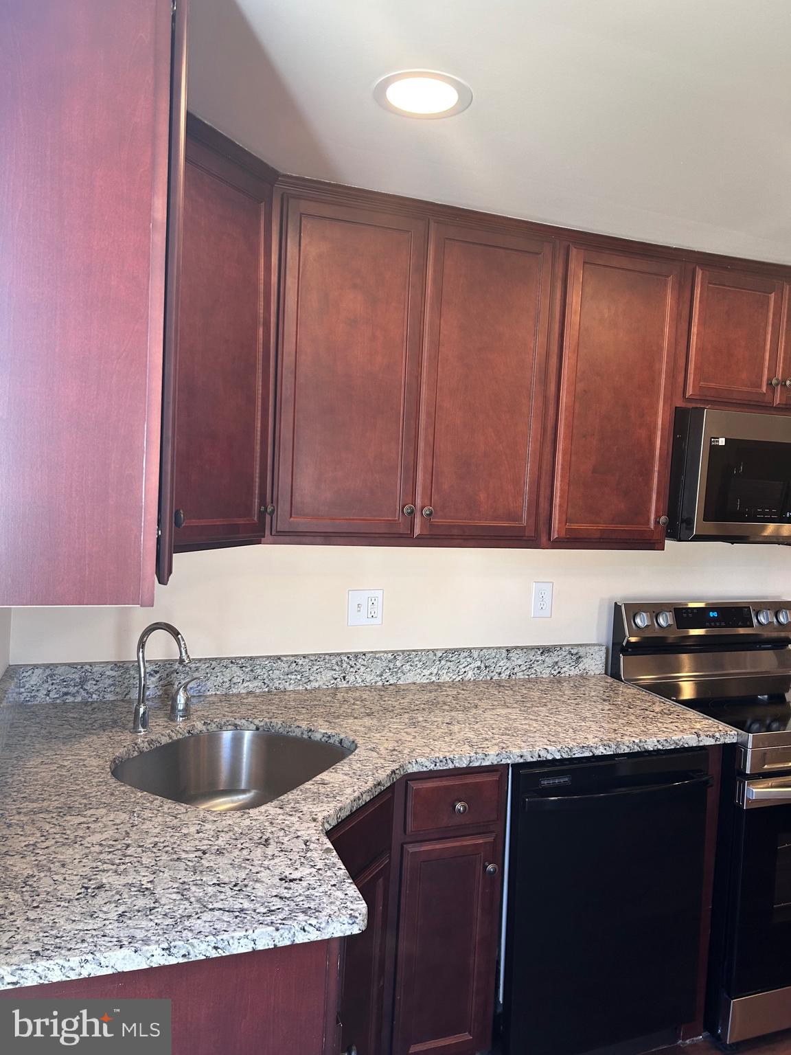 7617 Windsor Mill Road Windsor Mill, MD 21244 - Photo 8 of 49 a kitchen with granite countertop a sink a stove and cabinets