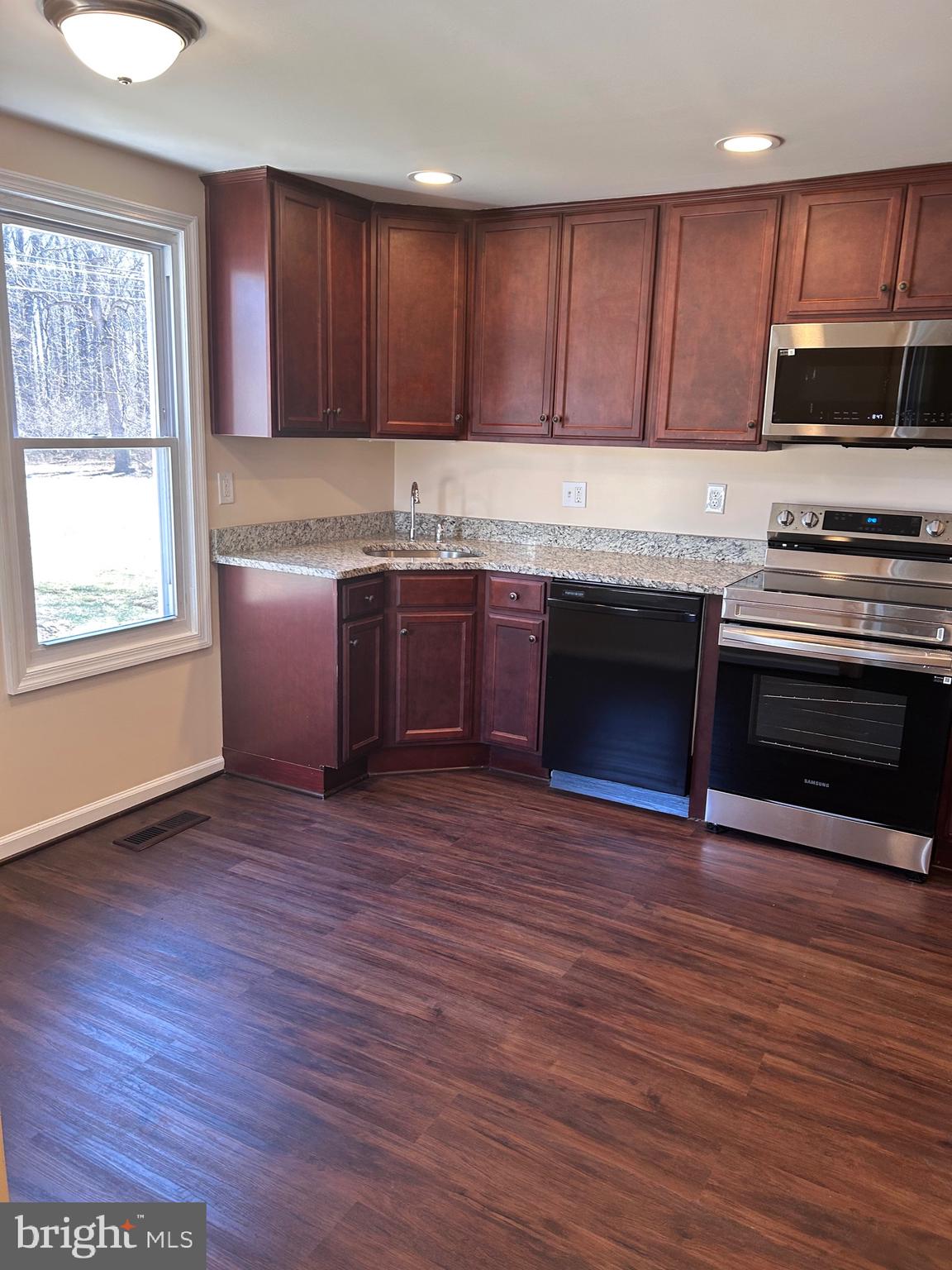 7617 Windsor Mill Road Windsor Mill, MD 21244 - Photo 9 of 49 a kitchen with stainless steel appliances granite countertop a stove a sink and a microwave