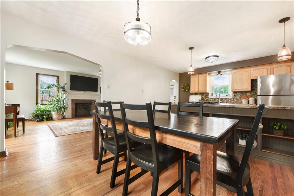 4043 Shoreham Street Pittsburgh, PA 15212 - Photo 12 of 45 a dining room with furniture a chandelier and wooden floor