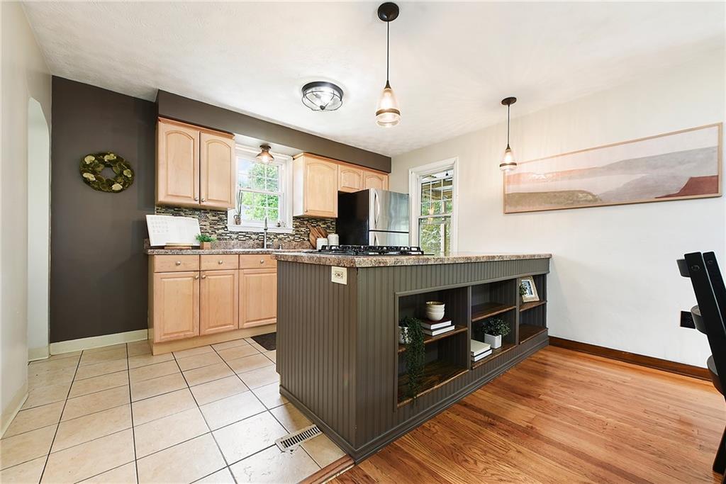 4043 Shoreham Street Pittsburgh, PA 15212 - Photo 16 of 45 a kitchen with stainless steel appliances granite countertop a stove a sink and a refrigerator