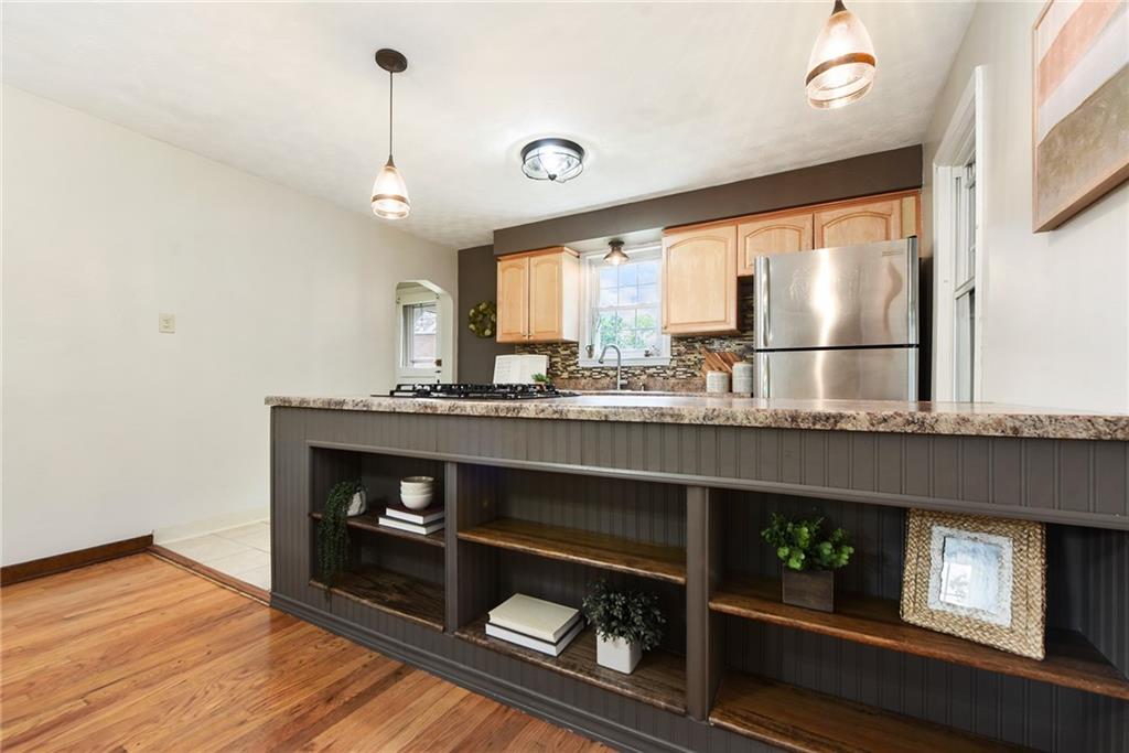 4043 Shoreham Street Pittsburgh, PA 15212 - Photo 17 of 45 a kitchen with a wooden floor and a large window