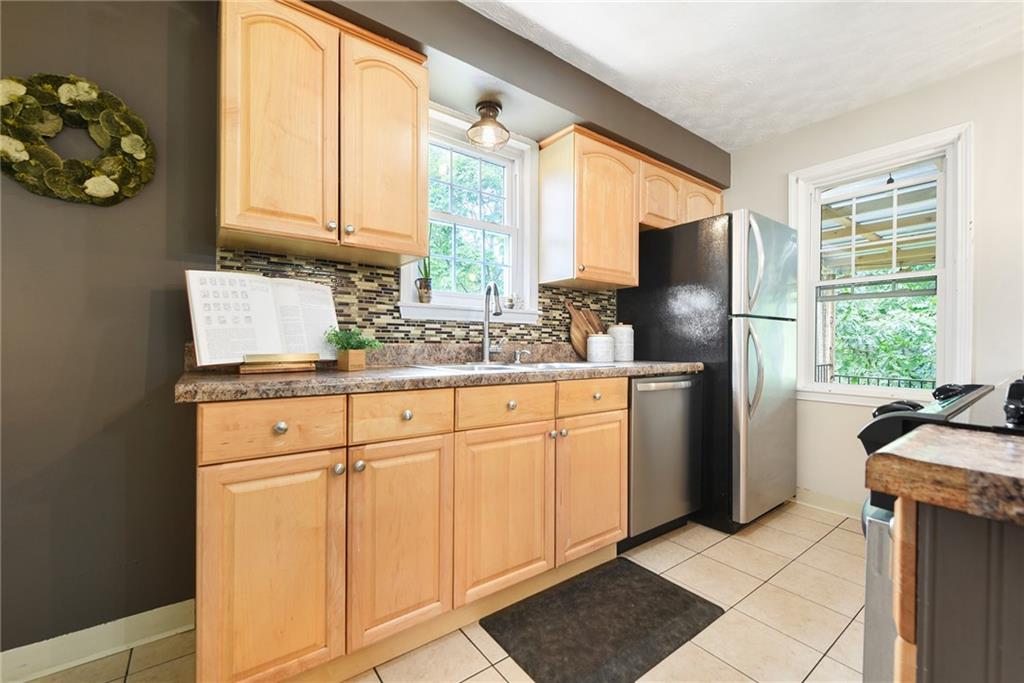 4043 Shoreham Street Pittsburgh, PA 15212 - Photo 18 of 45 a kitchen with stainless steel appliances granite countertop a refrigerator and a sink