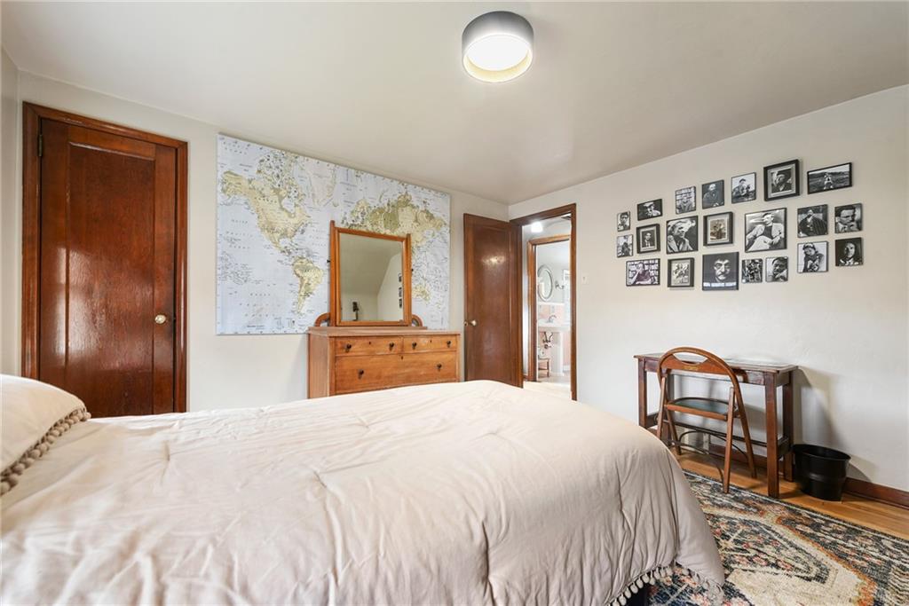 4043 Shoreham Street Pittsburgh, PA 15212 - Photo 29 of 45 a bedroom with a large bed and a table