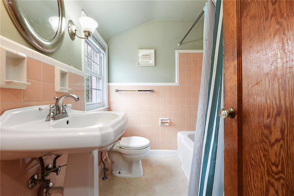 4043 Shoreham Street Pittsburgh, PA 15212 - Photo 33 of 45 a bathroom with a sink a toilet and mirror