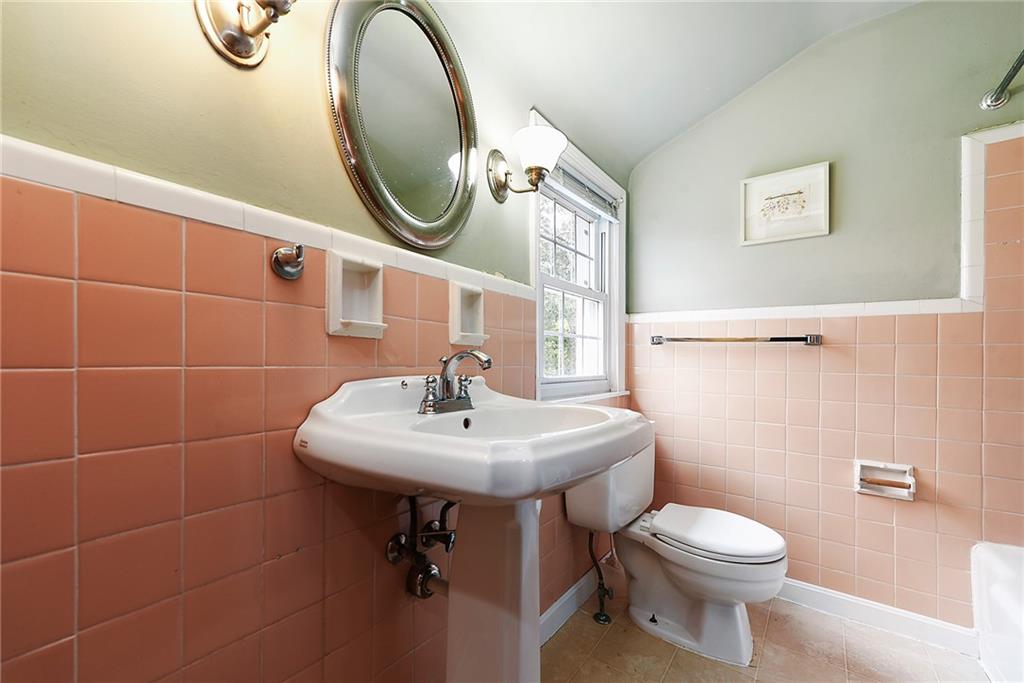 4043 Shoreham Street Pittsburgh, PA 15212 - Photo 34 of 45 a bathroom with a sink a toilet and a mirror