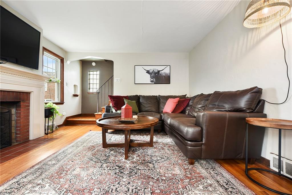 4043 Shoreham Street Pittsburgh, PA 15212 - Photo 9 of 45 a living room with furniture a fireplace and a flat screen tv