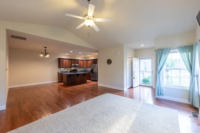a view of a livingroom with a kitchen counter tops and a window