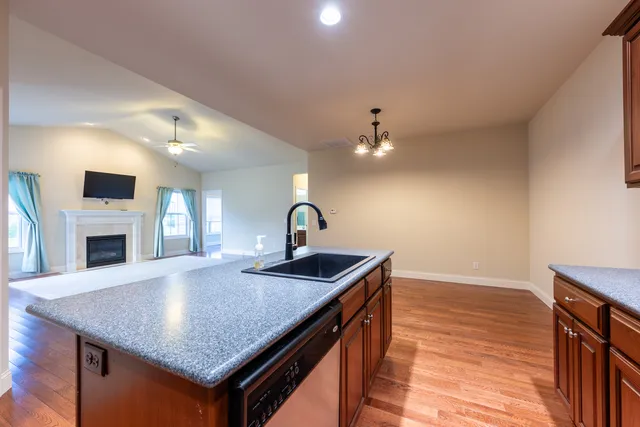 a kitchen with sink cabinets and fireplace