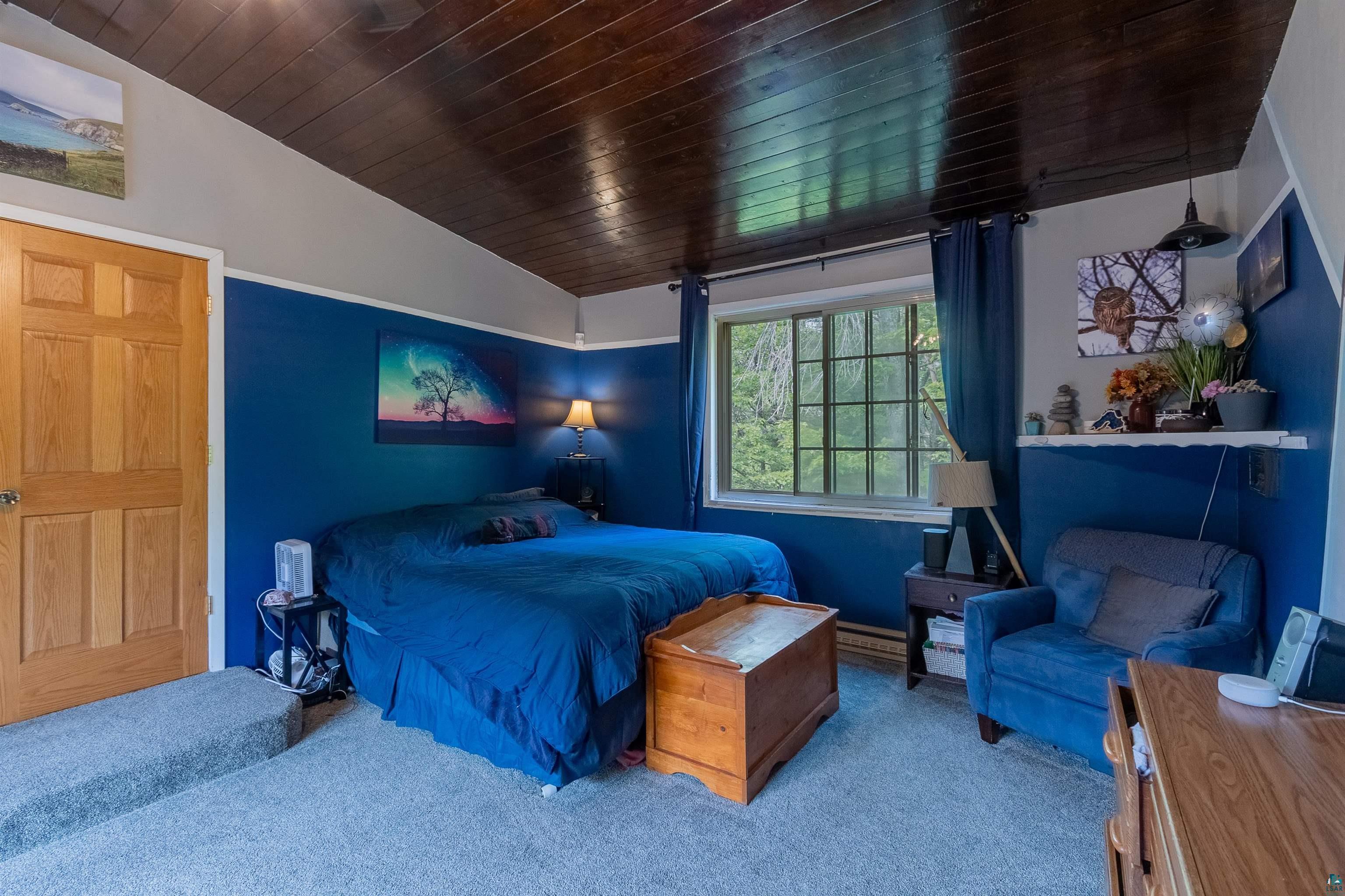 3976 Lavaque Road Hermantown, MN 55811 - Photo 21 of 38 Carpeted bedroom featuring lofted ceiling and wood ceiling