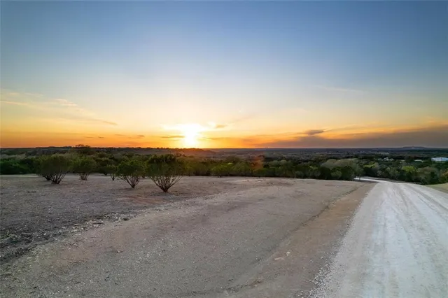 a view of a dry yard with mountain view