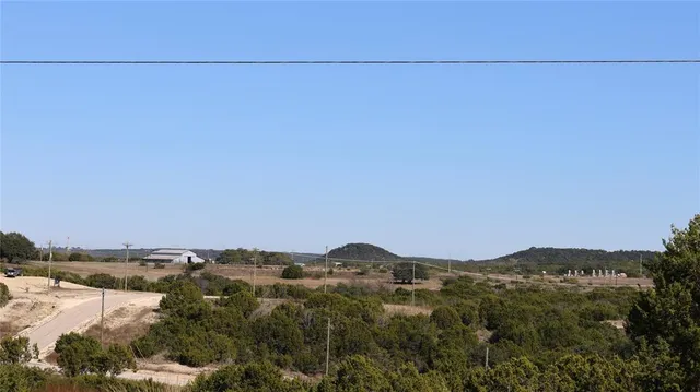 a view of a city with lush green forest
