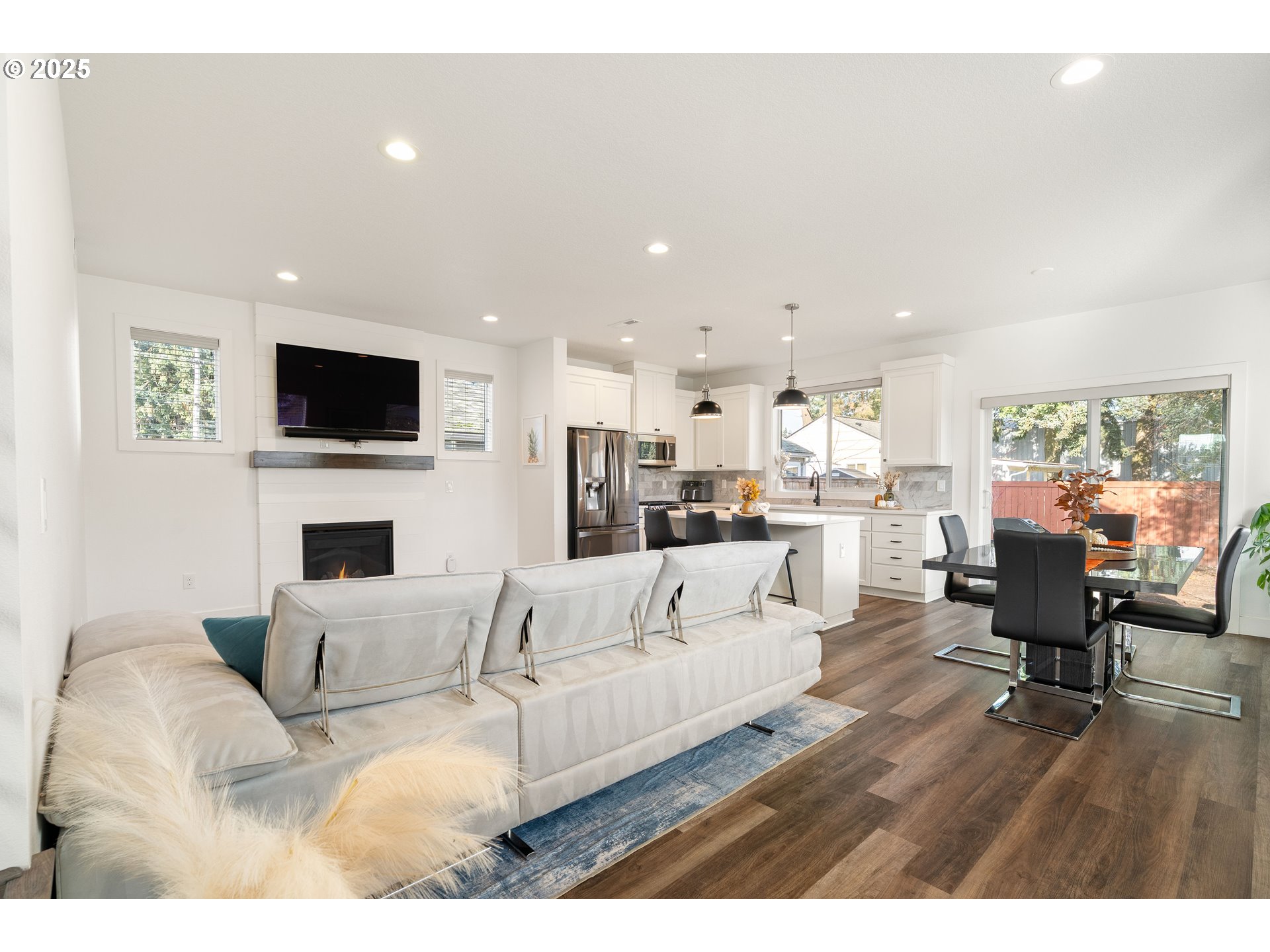 6421 Southeast Cooper Street Portland, OR 97206 - Photo 11 of 44 a living room with fireplace furniture and a flat screen tv