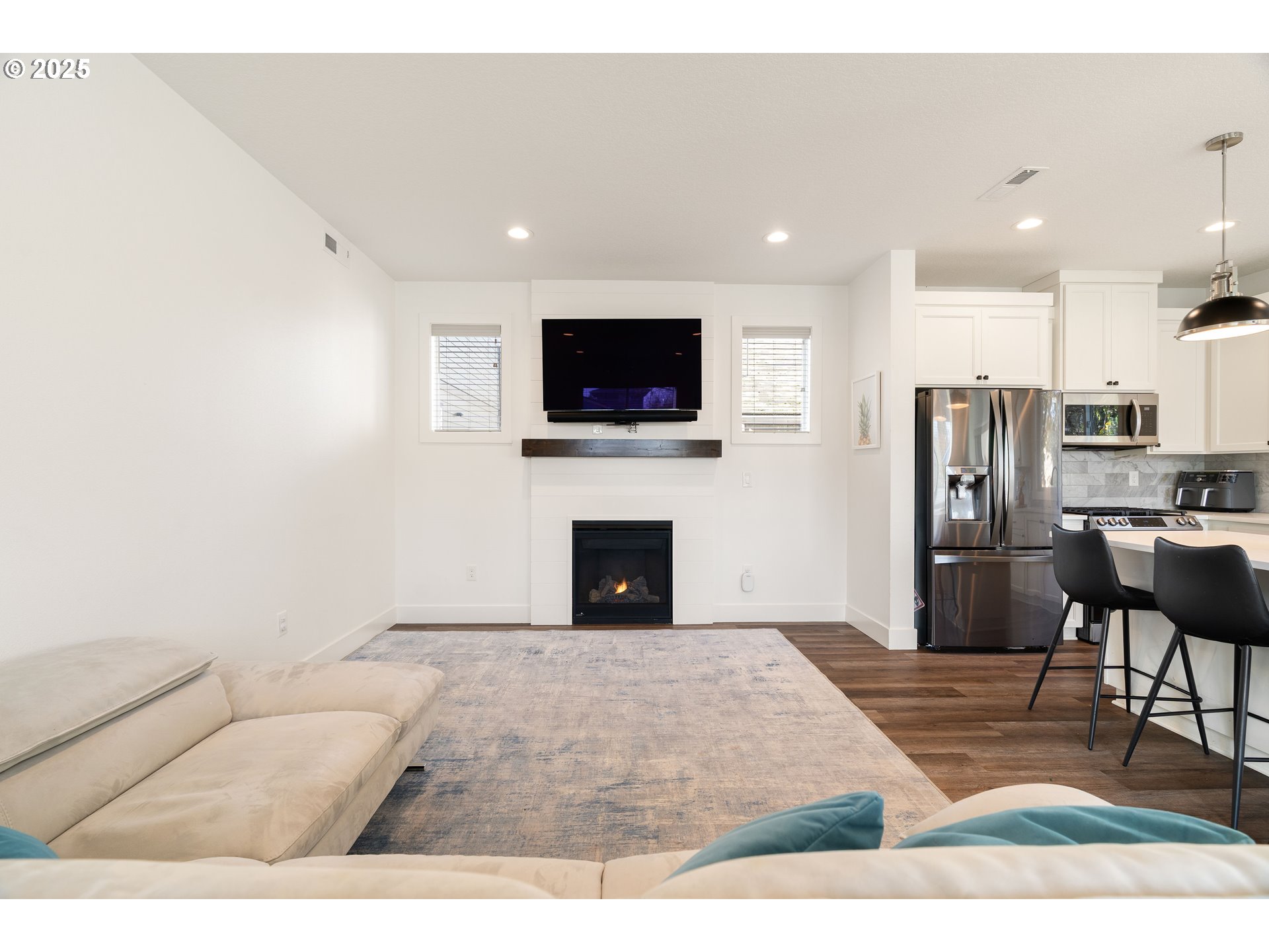 6421 Southeast Cooper Street Portland, OR 97206 - Photo 13 of 44 a living room with furniture a flat screen tv and a fireplace