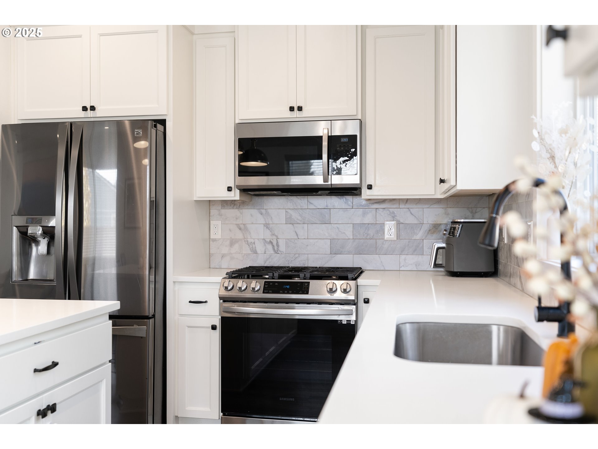 6421 Southeast Cooper Street Portland, OR 97206 - Photo 18 of 44 a kitchen with stainless steel appliances granite countertop a refrigerator sink and microwave