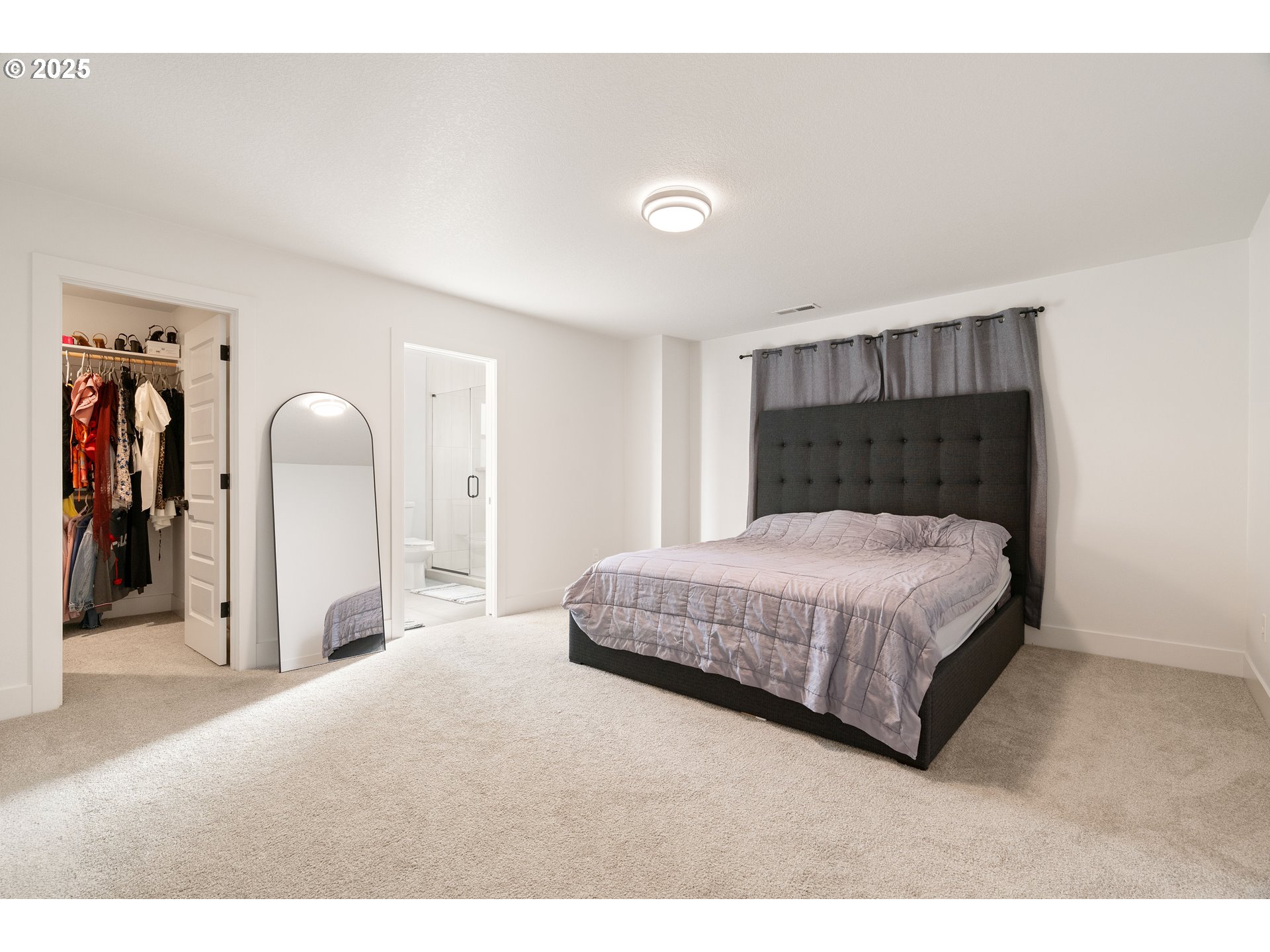 6421 Southeast Cooper Street Portland, OR 97206 - Photo 22 of 44 a bedroom with a bed and a painting on the wall