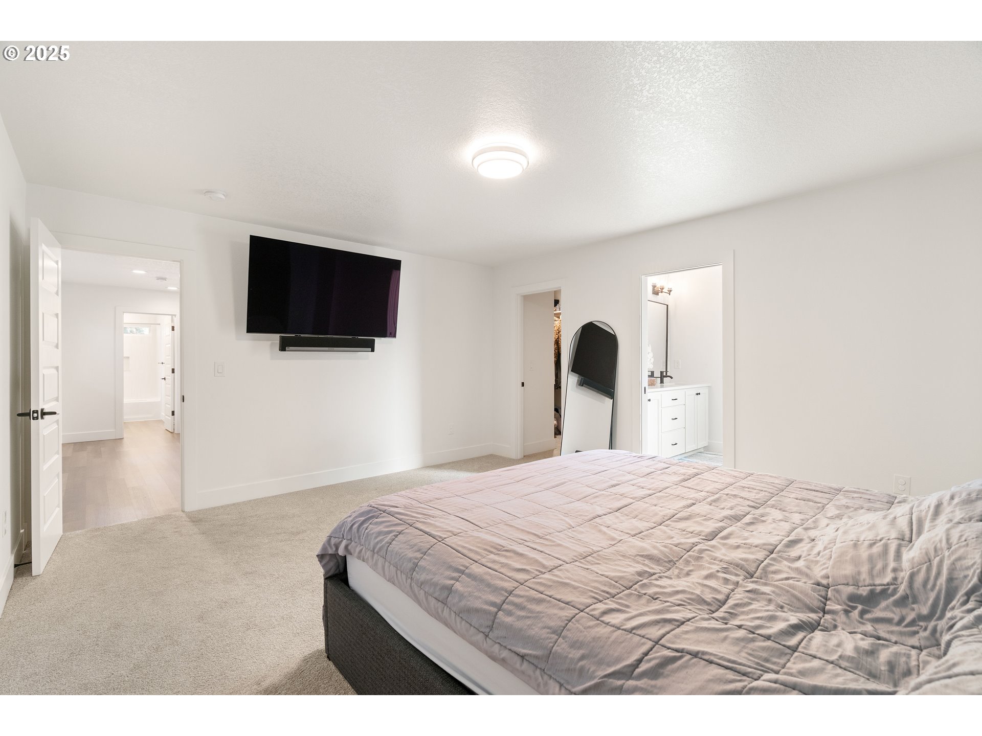 6421 Southeast Cooper Street Portland, OR 97206 - Photo 23 of 44 a bedroom with a bed and a flat screen tv