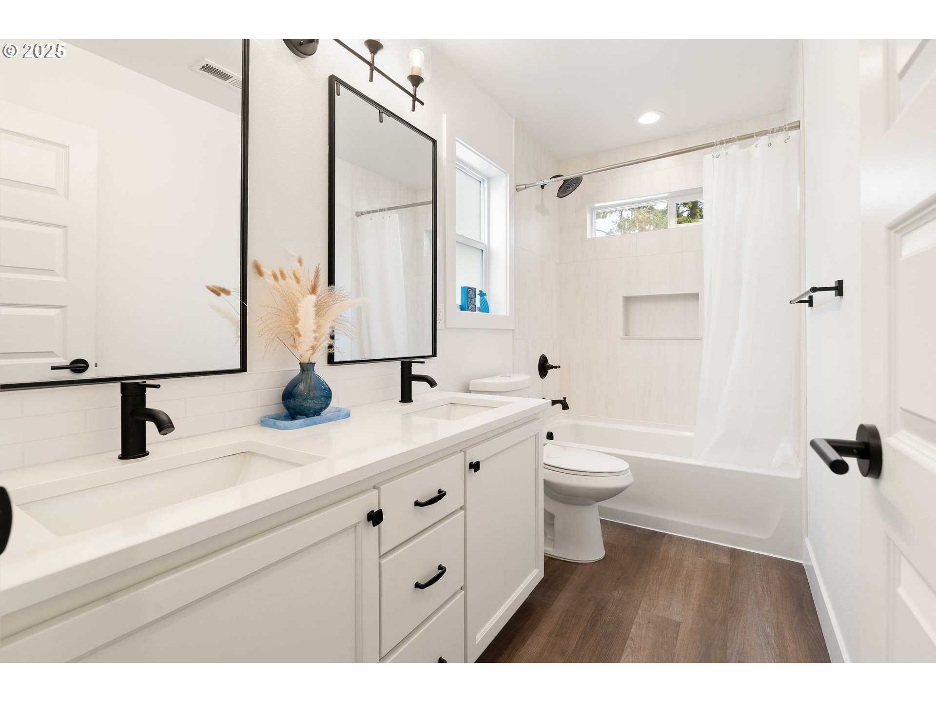 6421 Southeast Cooper Street Portland, OR 97206 - Photo 29 of 44 a bathroom with a double vanity sink a toilet and a mirror