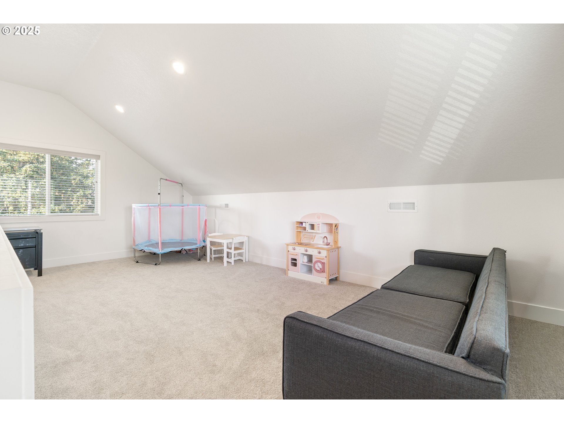 6421 Southeast Cooper Street Portland, OR 97206 - Photo 33 of 44 a room with a bed and a chair