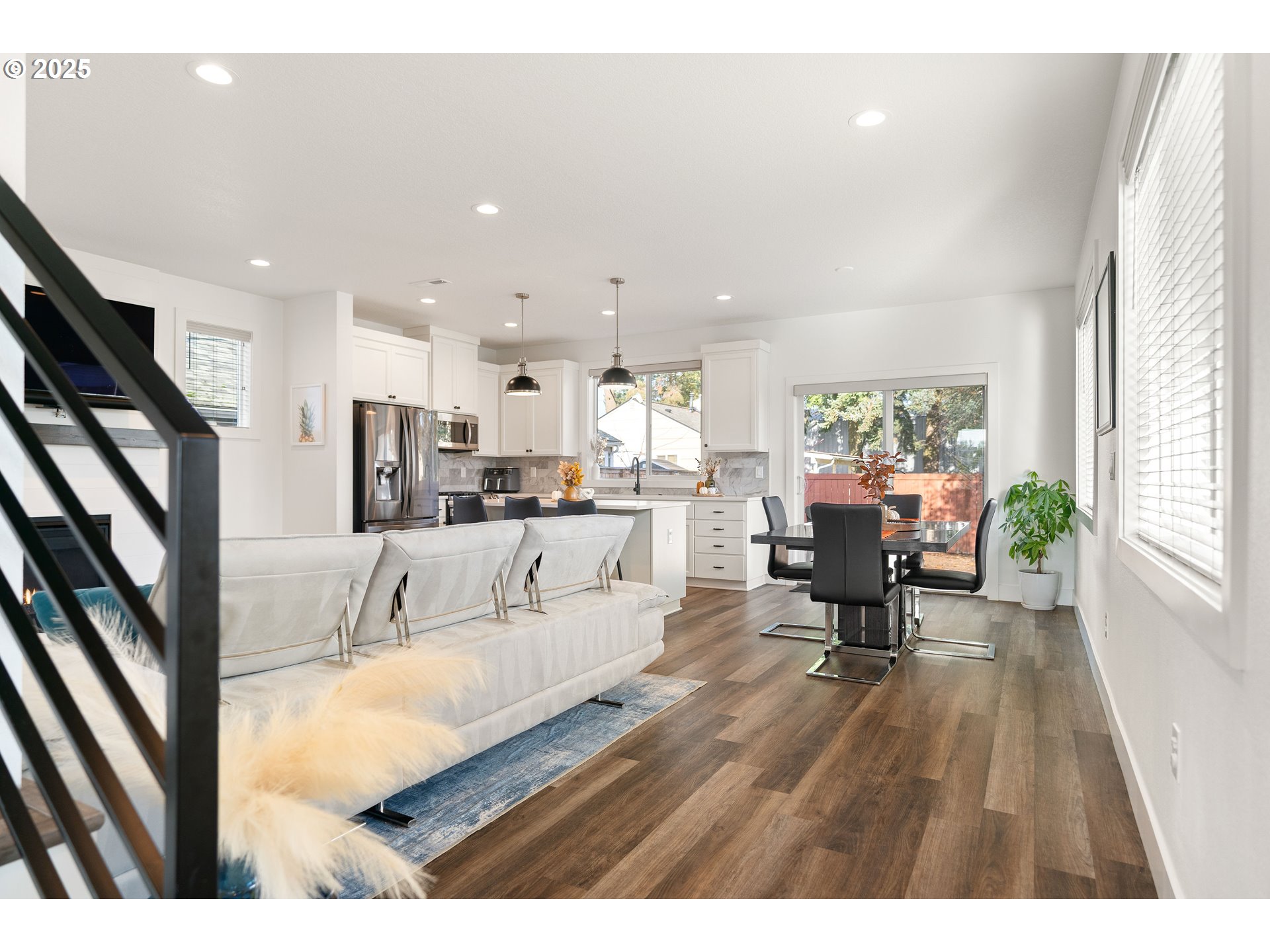 6421 Southeast Cooper Street Portland, OR 97206 - Photo 10 of 44 a living room with furniture and a dining table with kitchen view