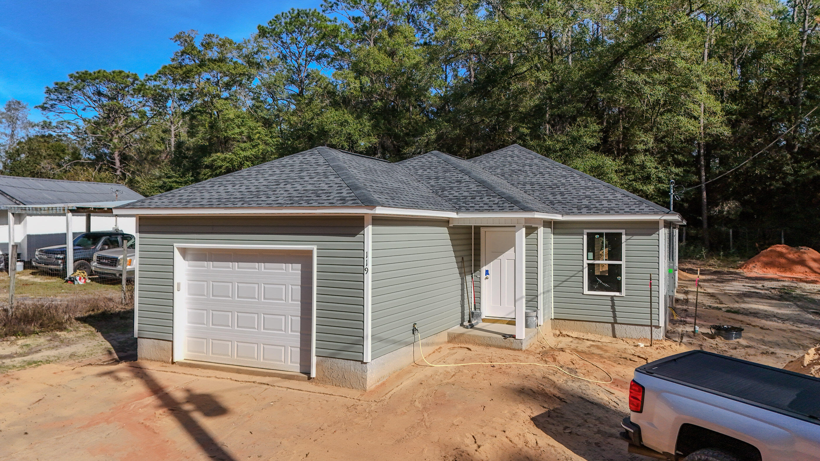119 Loftin Street DeFuniak Springs, FL 32435 - Photo 1 of 15 a house with trees in the background