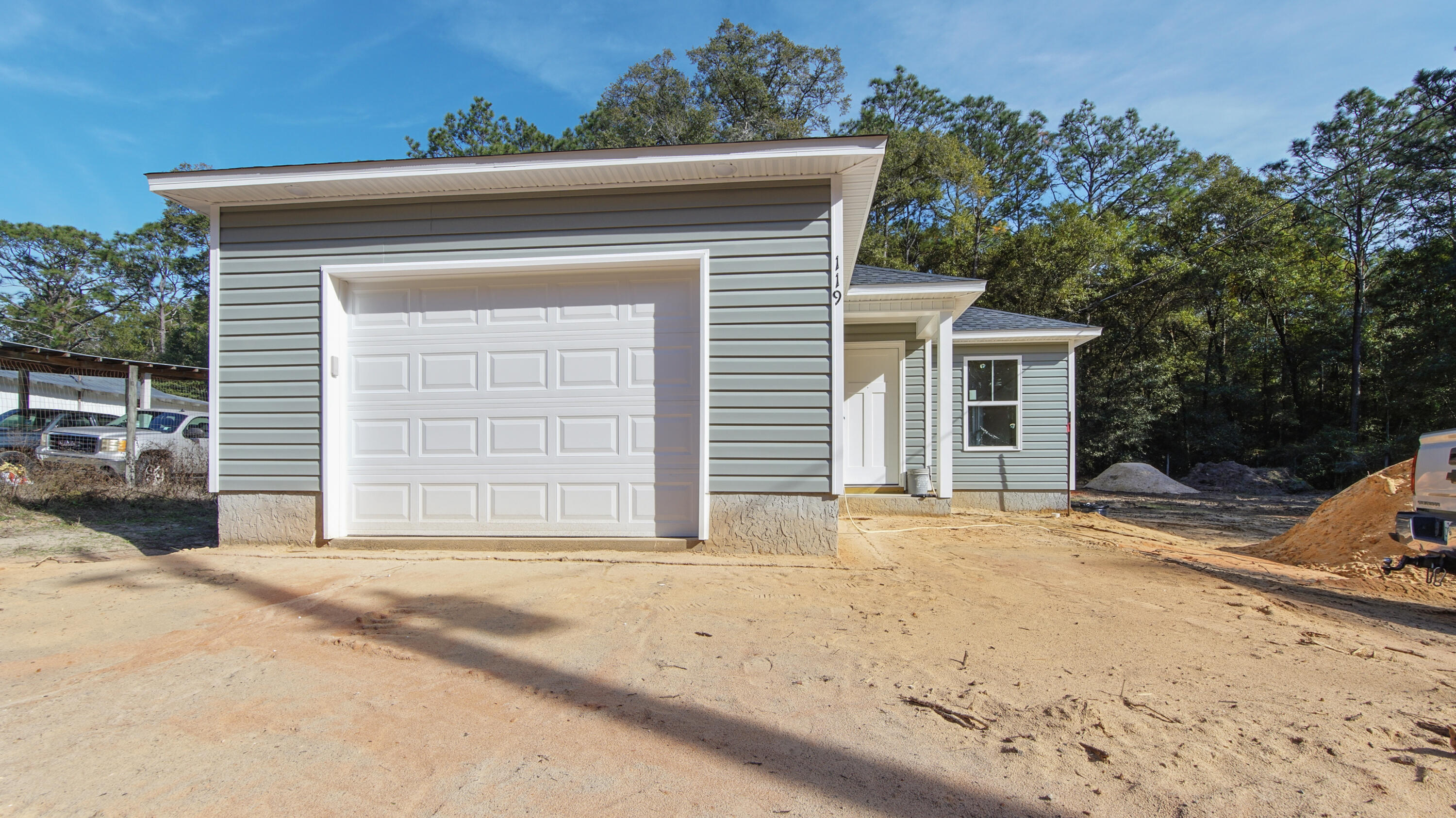 119 Loftin Street DeFuniak Springs, FL 32435 - Photo 14 of 15 a front view of a house with a yard and garage