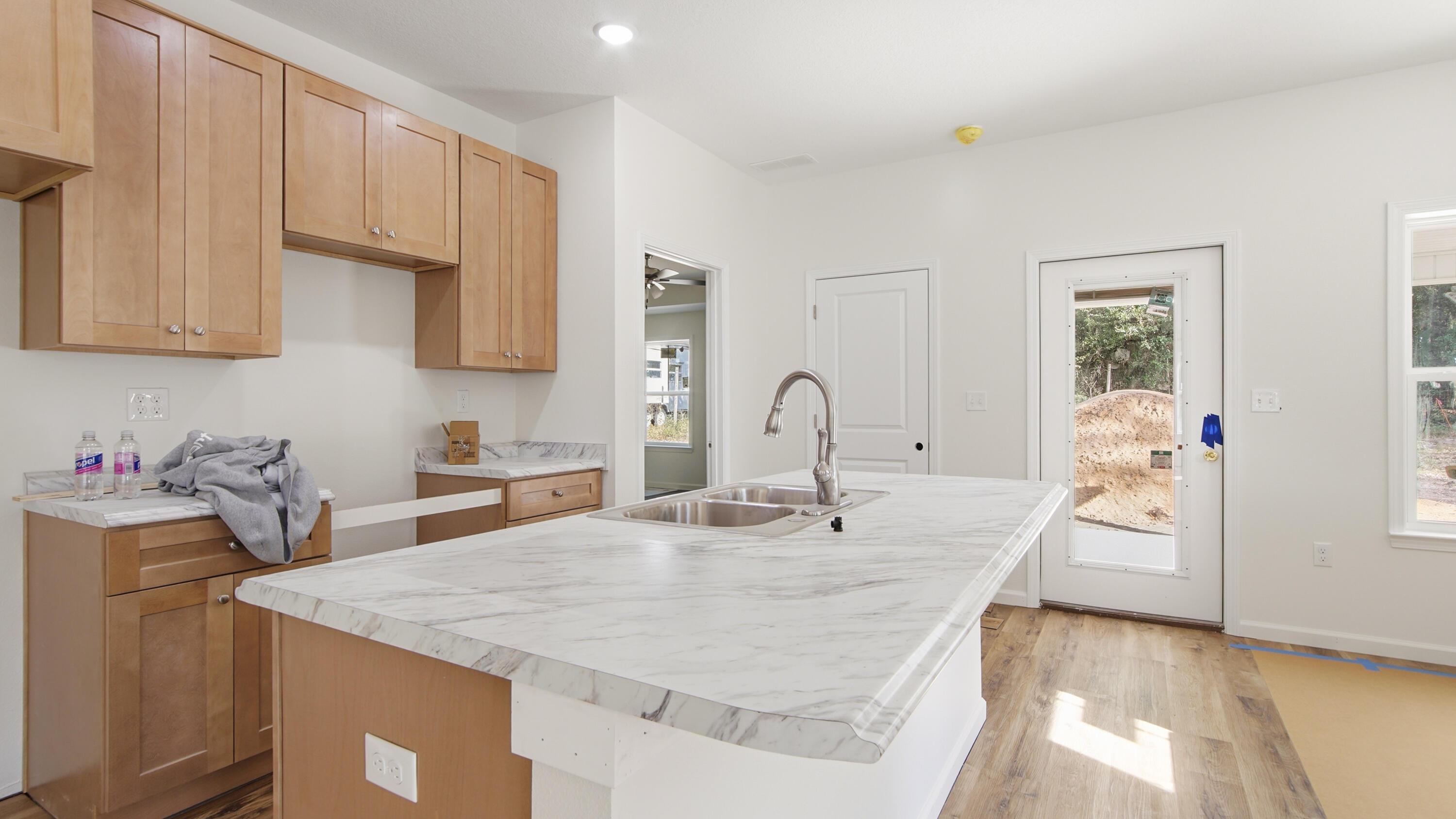 119 Loftin Street DeFuniak Springs, FL 32435 - Photo 3 of 15 a kitchen with granite countertop a sink a stove and cabinets
