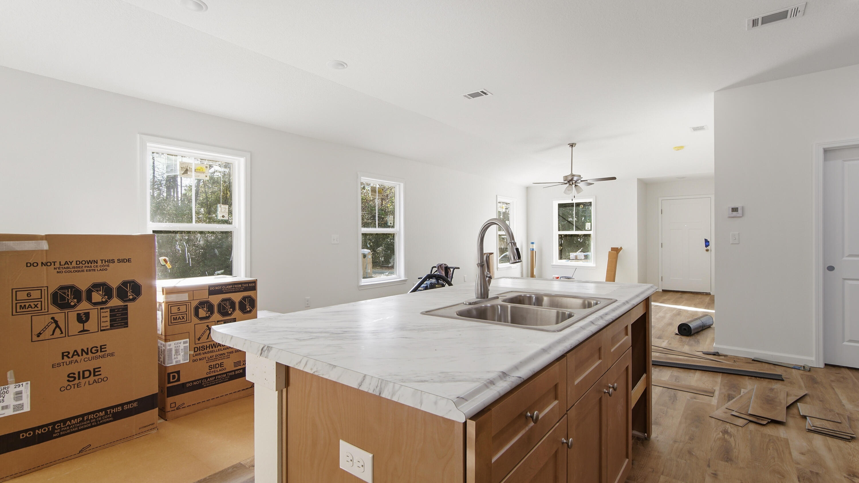 119 Loftin Street DeFuniak Springs, FL 32435 - Photo 4 of 15 a kitchen with granite countertop a sink a stove and cabinets