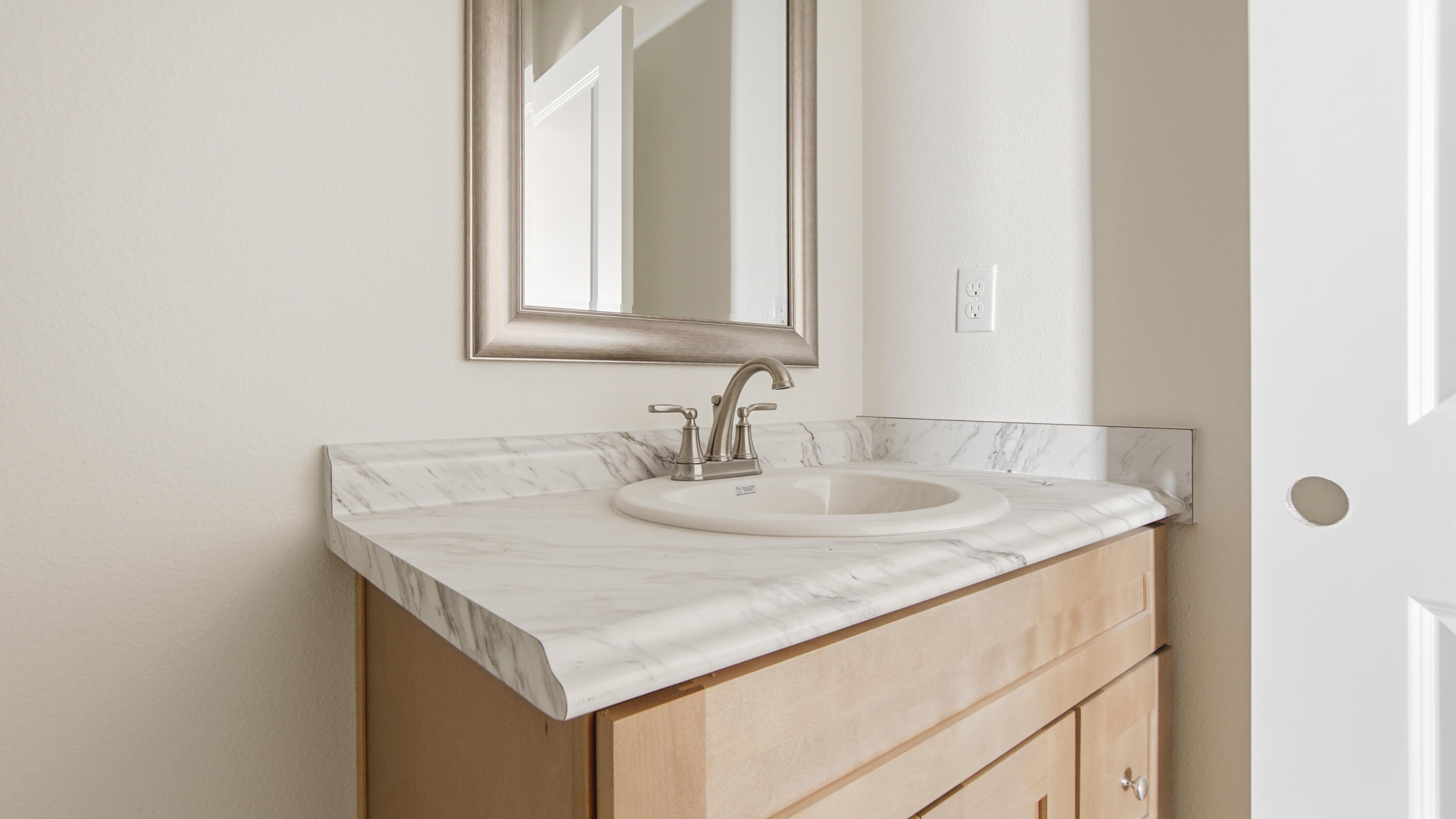 119 Loftin Street DeFuniak Springs, FL 32435 - Photo 8 of 15 a bathroom with a granite countertop sink and a mirror