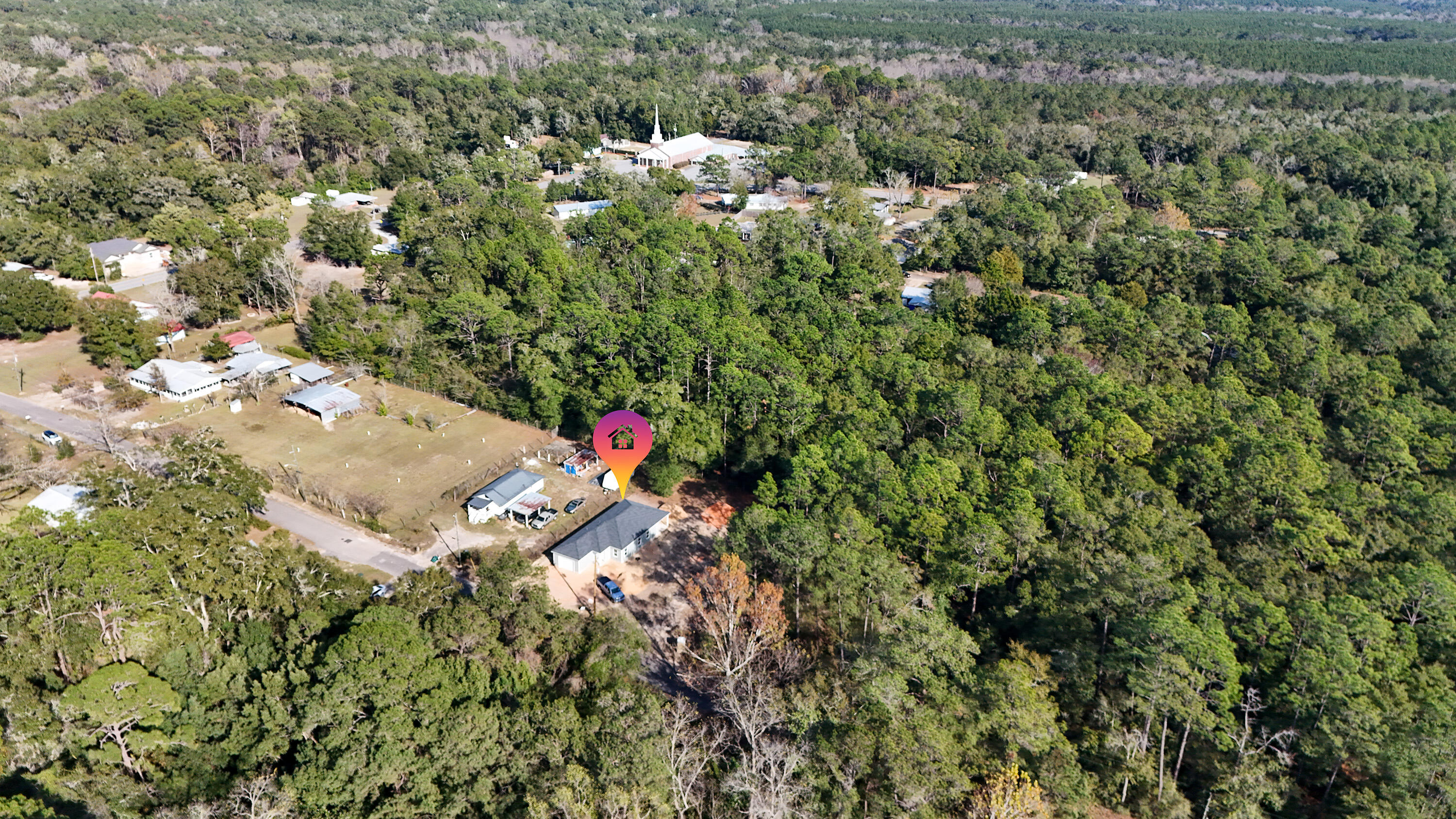 119 Loftin Street DeFuniak Springs, FL 32435 - Photo 10 of 15 a view of a house with a lush green forest