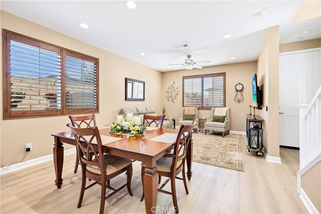 39320 Brunello Way Temecula, CA 92591 - Photo 15 of 52 a view of a a dining room with furniture window and wooden floor