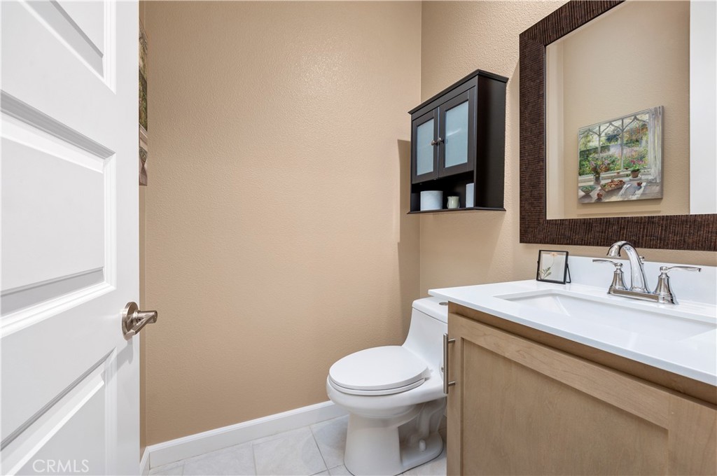 39320 Brunello Way Temecula, CA 92591 - Photo 17 of 52 a bathroom with a toilet a sink and mirror