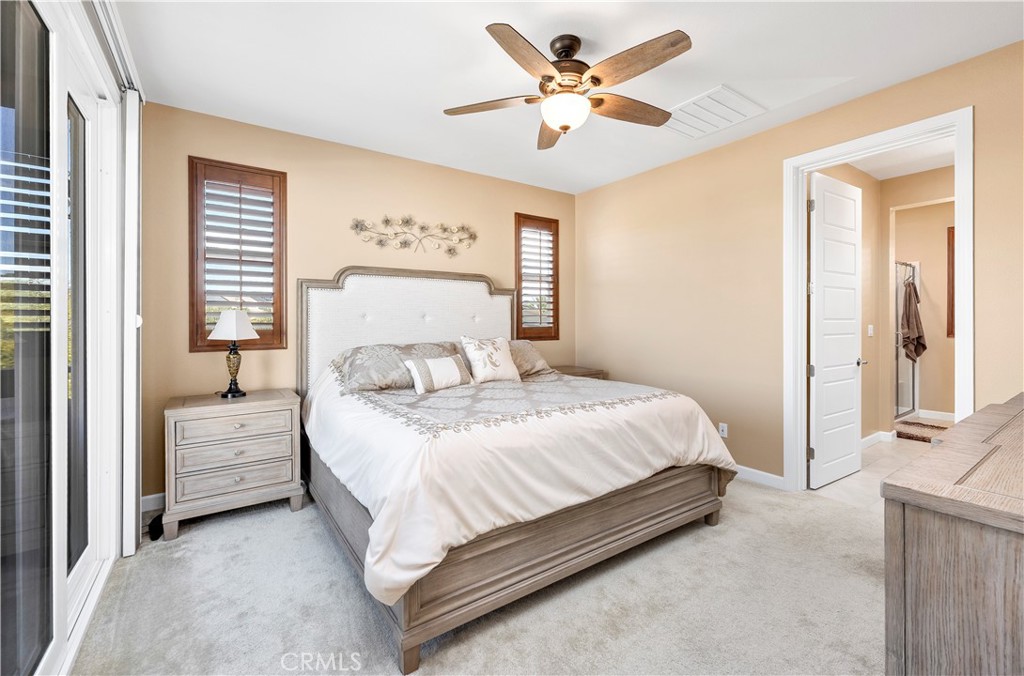 39320 Brunello Way Temecula, CA 92591 - Photo 18 of 52 a bedroom with a bed and a chandelier