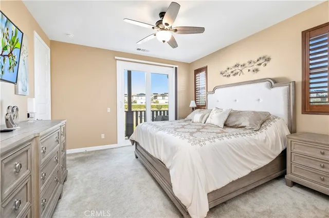 a spacious bedroom with a bed and a chandelier
