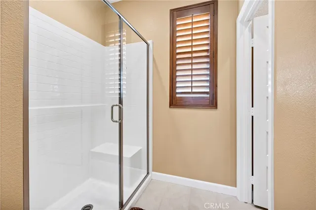 a bathroom with a shower and a window