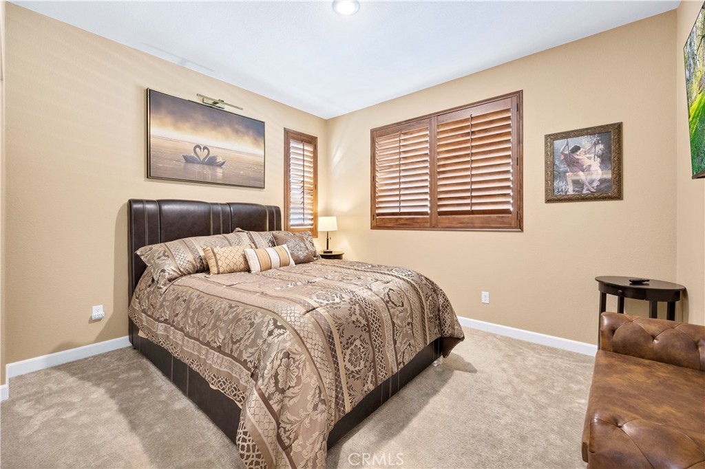 39320 Brunello Way Temecula, CA 92591 - Photo 25 of 52 a bedroom with a bed and a painting on the wall