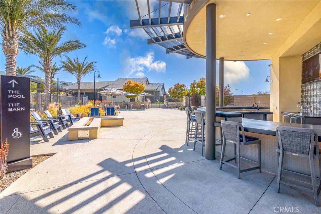 39320 Brunello Way Temecula, CA 92591 - Photo 37 of 52 a view of a patio with swimming pool table and chairs