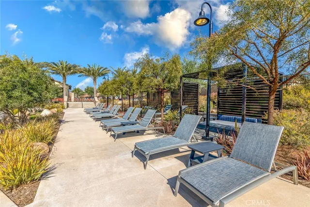 a view of swimming pool with lounge chair and dinning tables