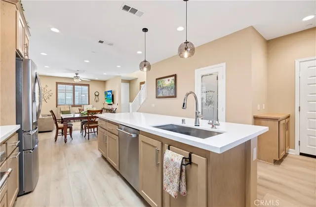 a large kitchen with a table and chairs