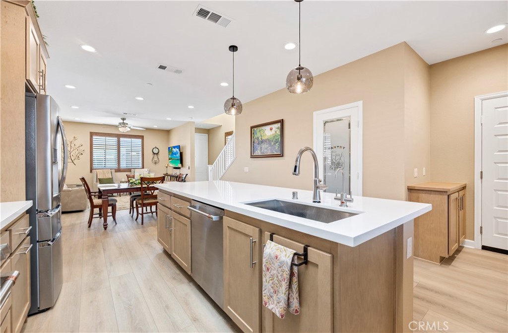 39320 Brunello Way Temecula, CA 92591 - Photo 7 of 52 a large kitchen with a table and chairs