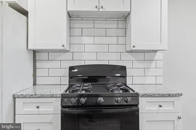 a stove top oven sitting inside of a kitchen