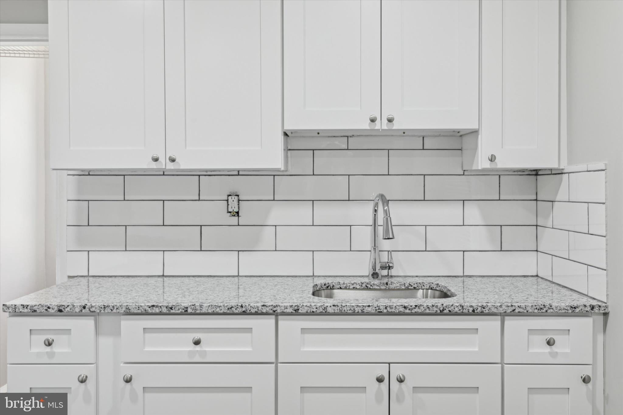 326 East Airy Street, Unit 1 Norristown, PA 19401 - Photo 3 of 11 a kitchen with granite countertop white cabinets and a stove