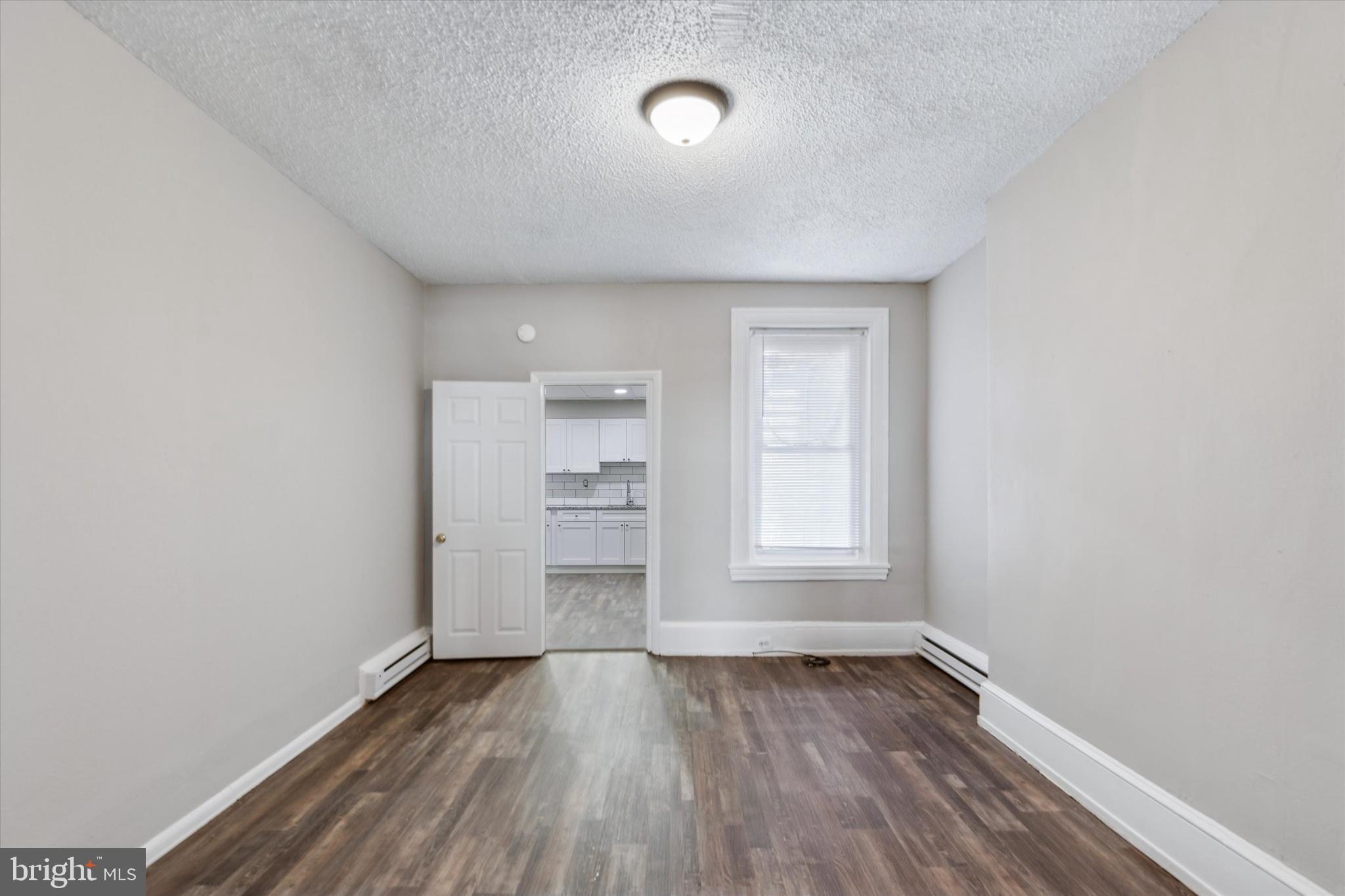 326 East Airy Street, Unit 1 Norristown, PA 19401 - Photo 7 of 11 an empty room with wooden floor and windows