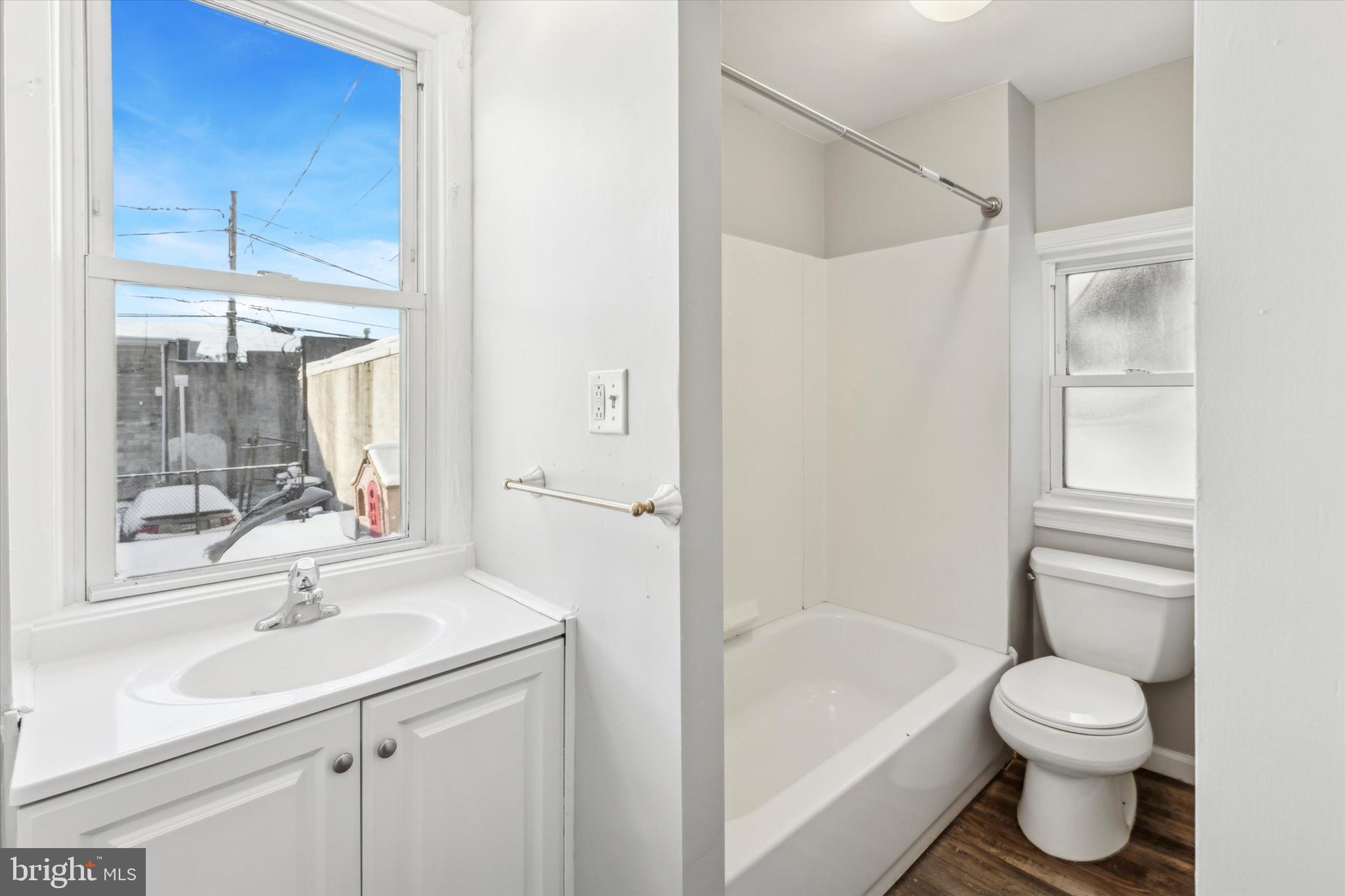 326 East Airy Street, Unit 1 Norristown, PA 19401 - Photo 10 of 11 a bathroom with a bathtub shower sink vanity mirror and toilet