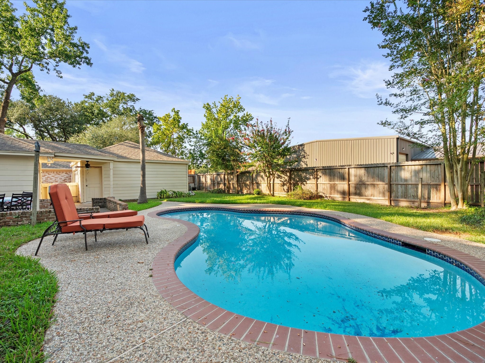 a view of a swimming pool with a lounge chair