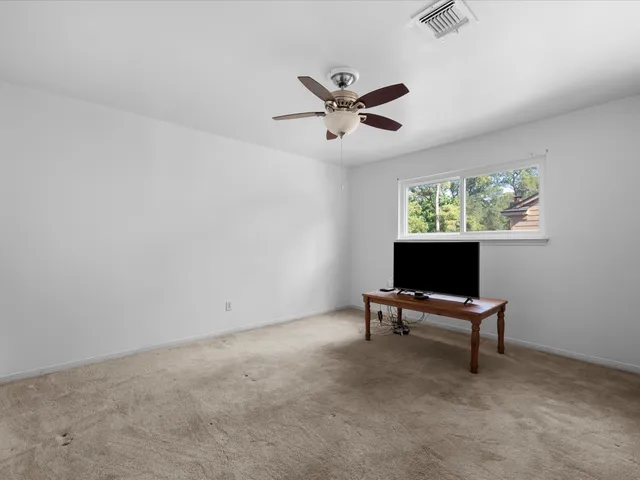 a view of room with a ceiling fan