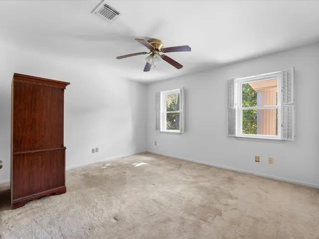 an empty room with windows and closet