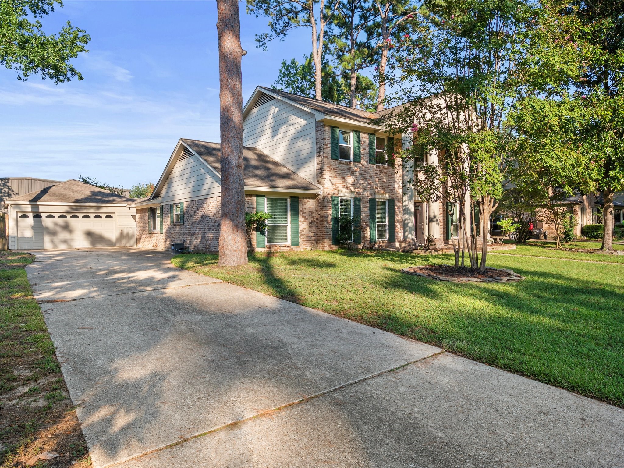 13718 Balmore Circle Houston, TX 77069 - Photo 2 of 35 a view of a big house with a big yard and large tree