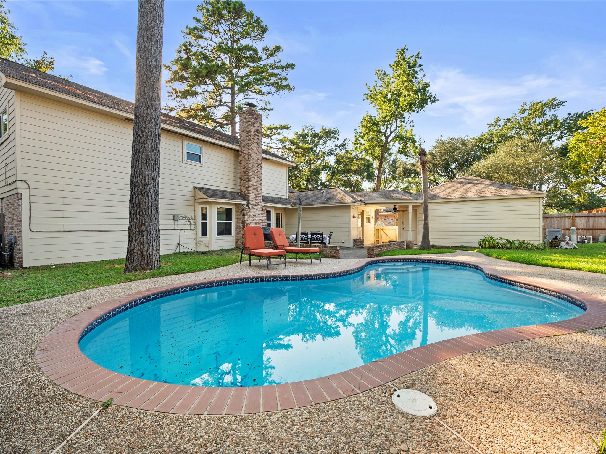 13718 Balmore Circle Houston, TX 77069 - Photo 27 of 35 a view of swimming pool with seating space and trees in the background